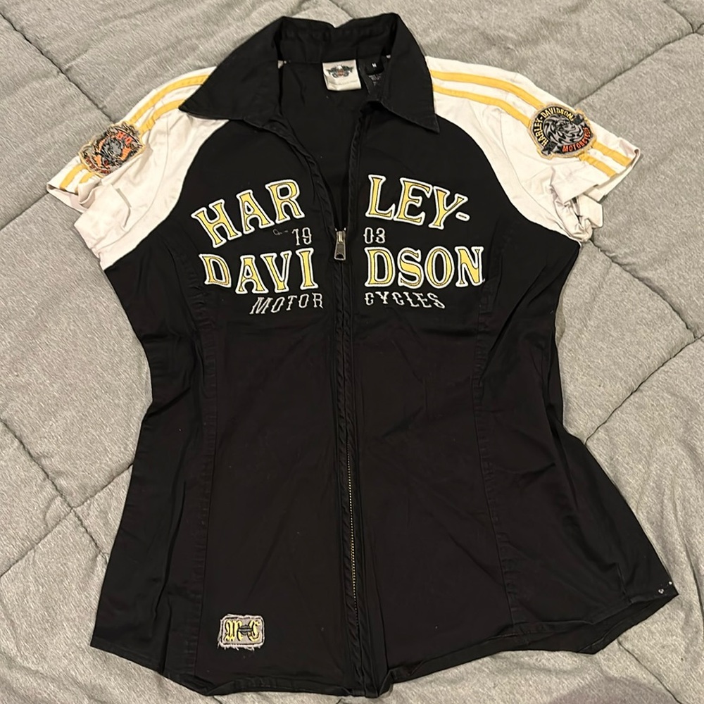 Harley-Davidson. Size M. Black with white sleeves and yellow writing. Zip up.